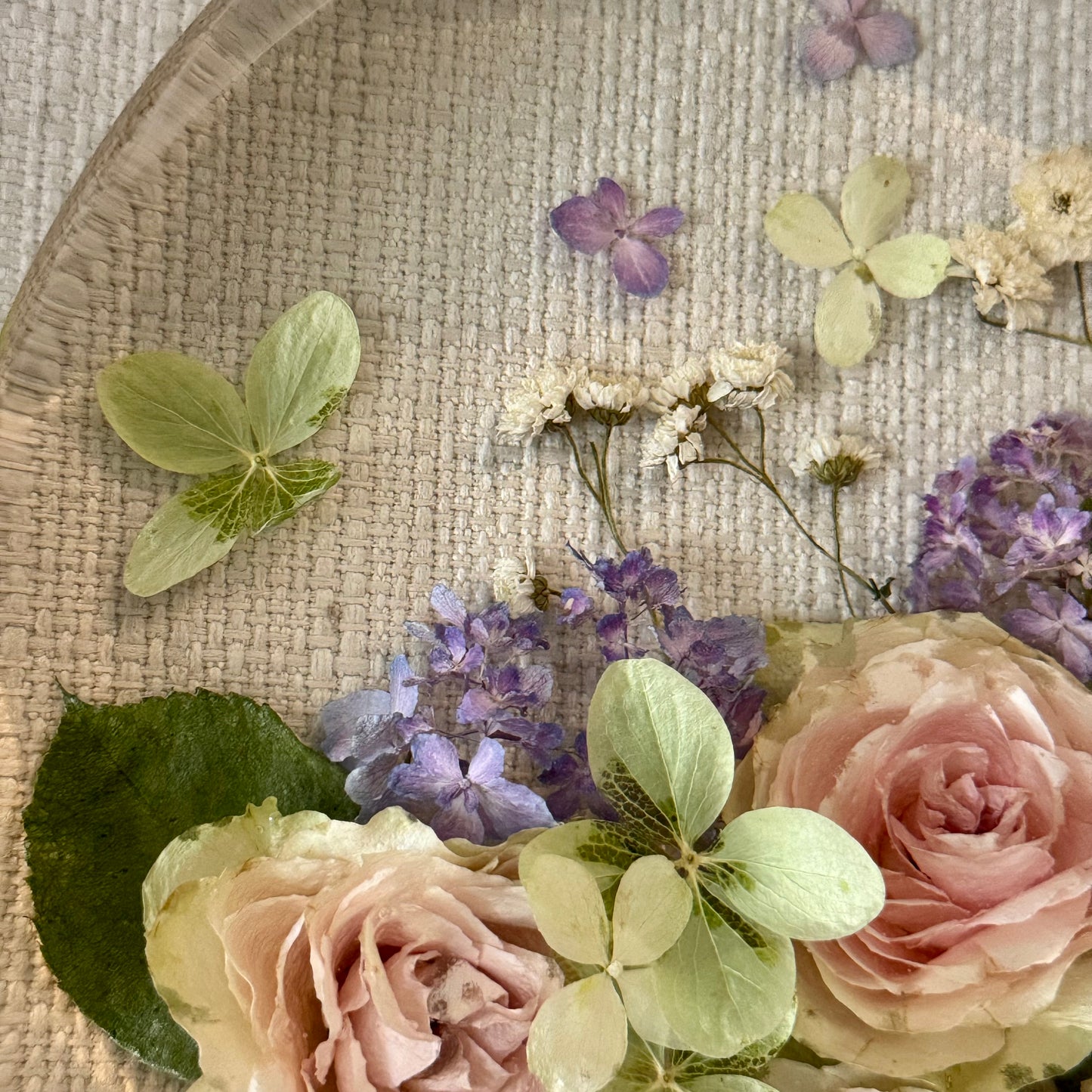 Preserved wedding bouquet of roses and hydrangeas in a circle resin block