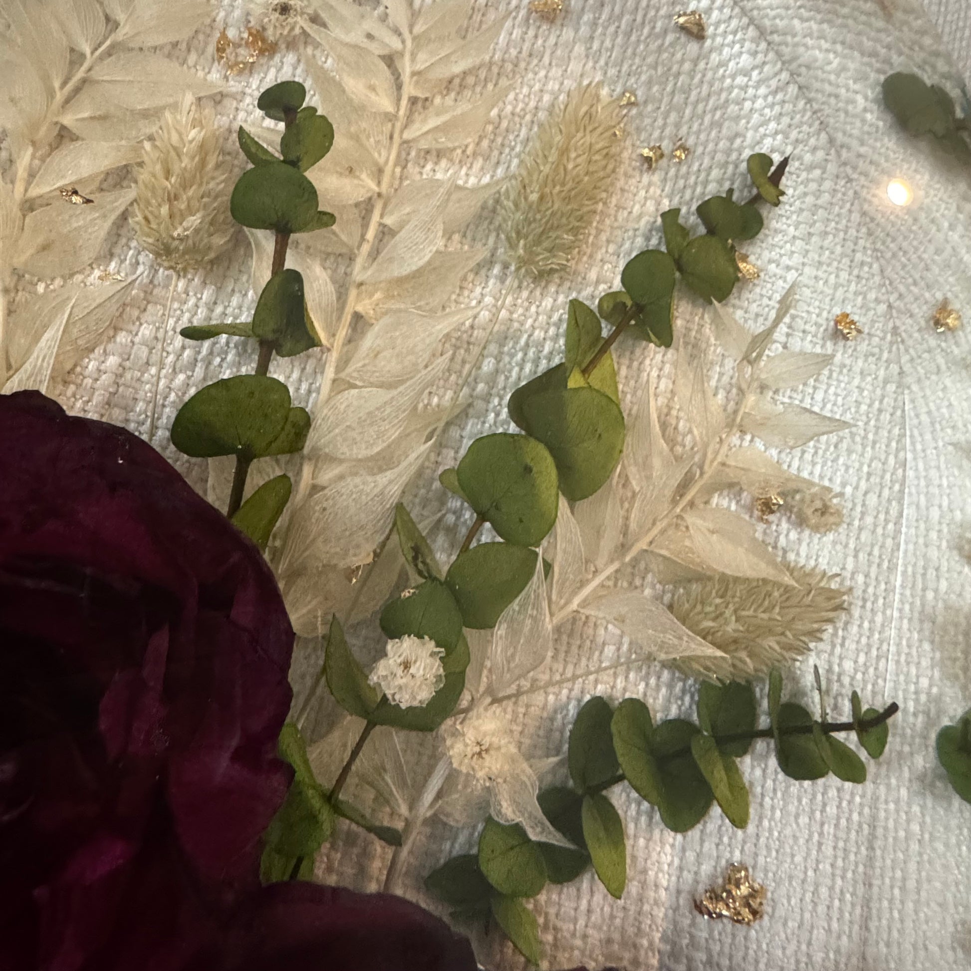 Flowers preserved in resin with gold flake and eucalyptus stems