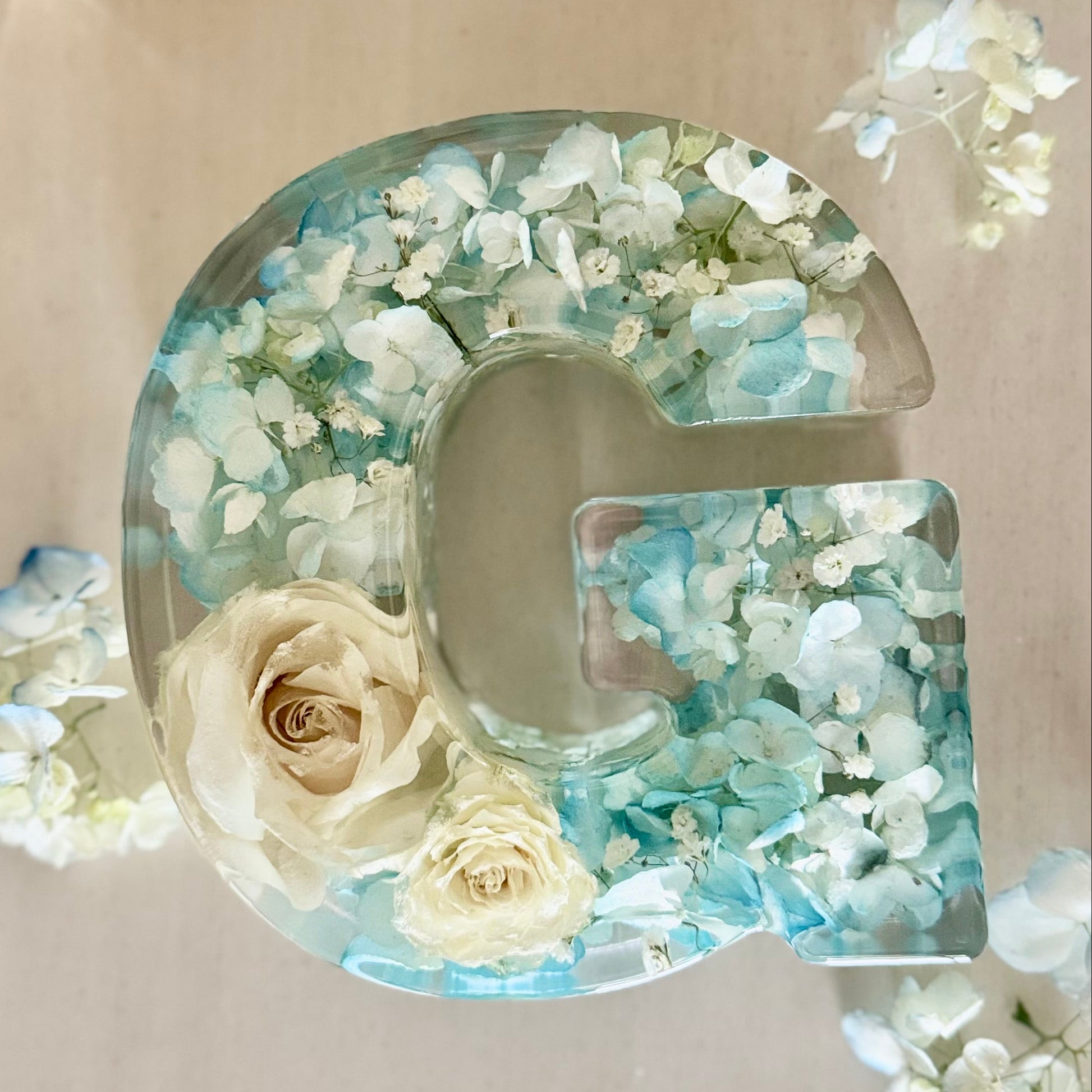 Flat lay of Floral resin letter by The Blossom Grove featuring real preserved flowers from baby shower